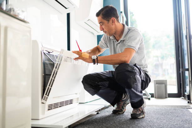 Technician cleaning air conditioner filter